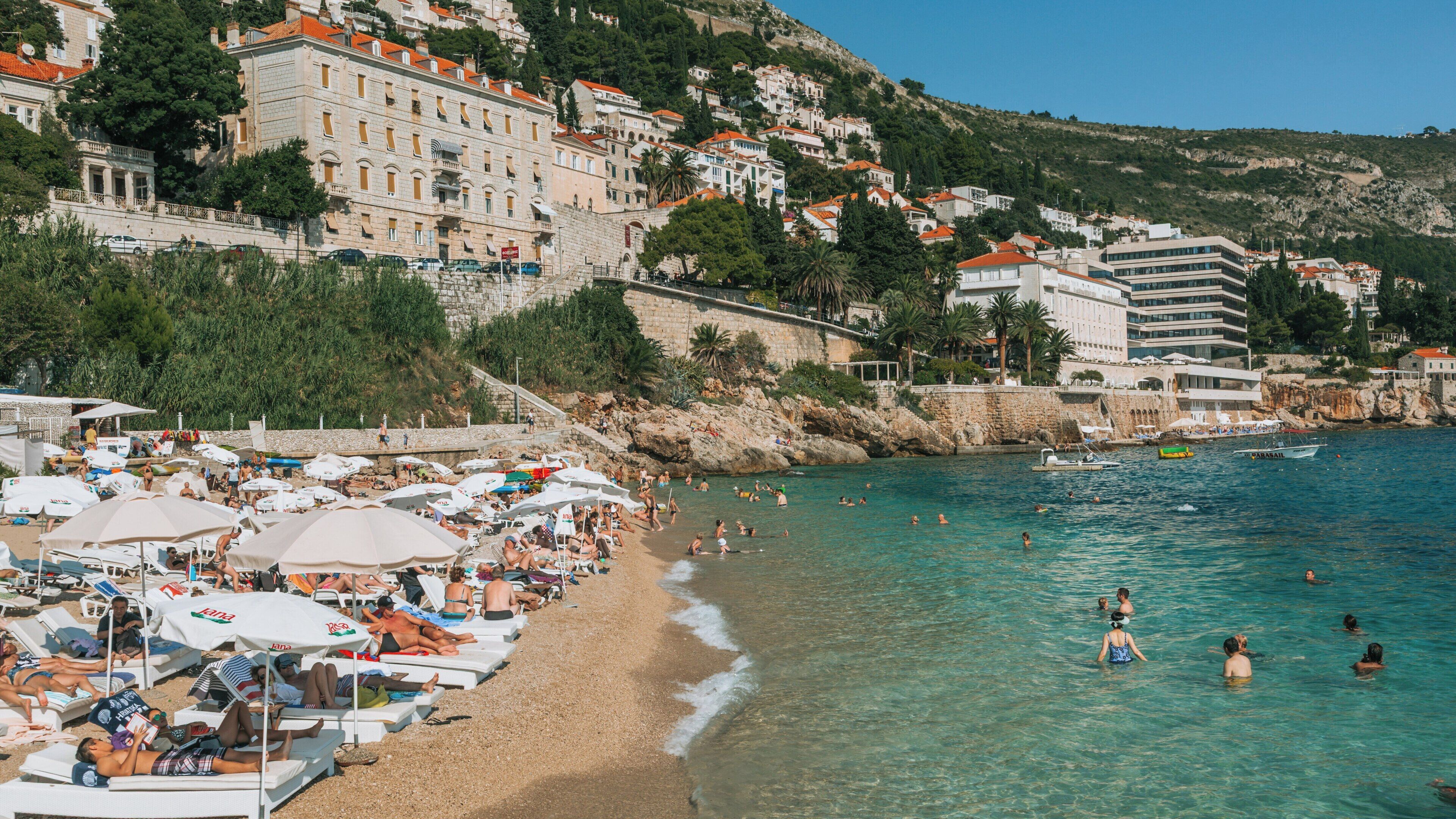 Banje Beach offers a sunny retreat with crystal-clear waters and stunning views in Ploce, Dubrovnik, Croatia on a warm summer day