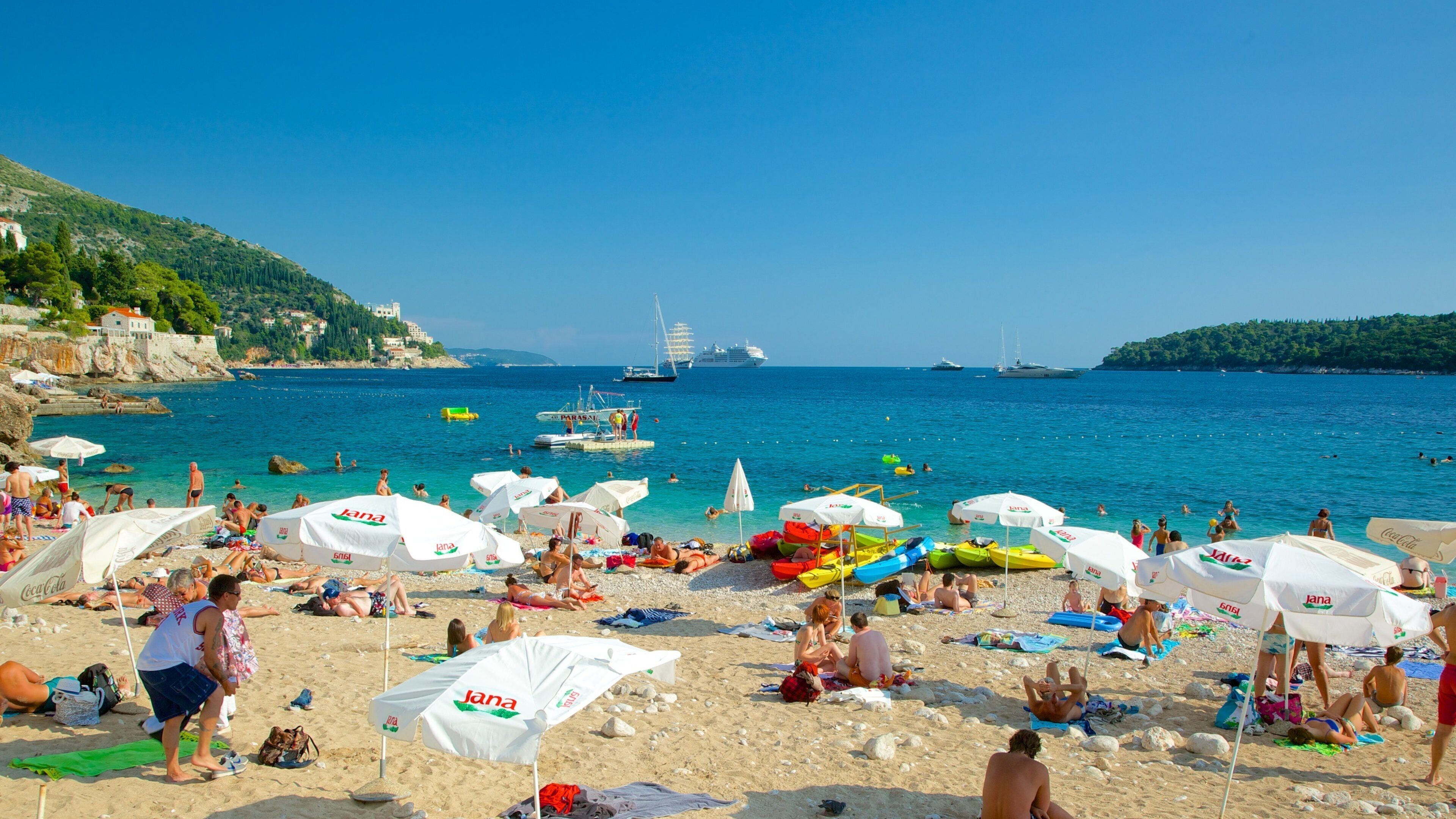 Banje Beach which includes a beach as well as a large group of people