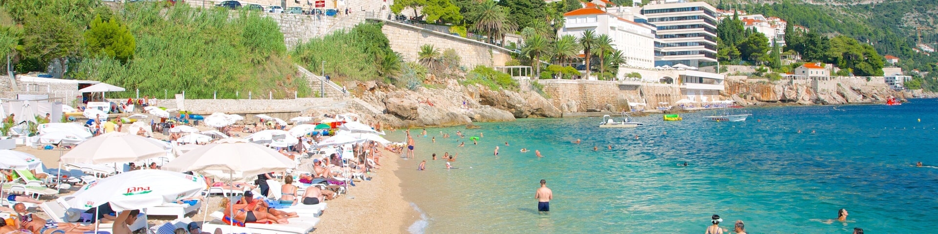 Banje Beach which includes a coastal town and a sandy beach