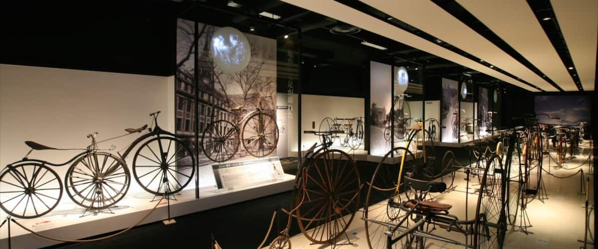 A museum exhibit with various vintage bicycles on display.
