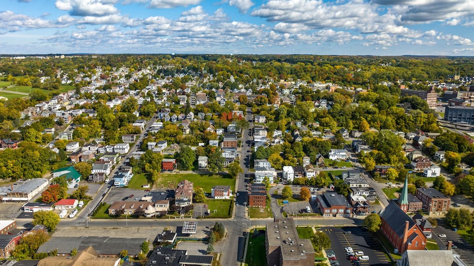 A suburban area with residential houses, a church, and a parking lot.