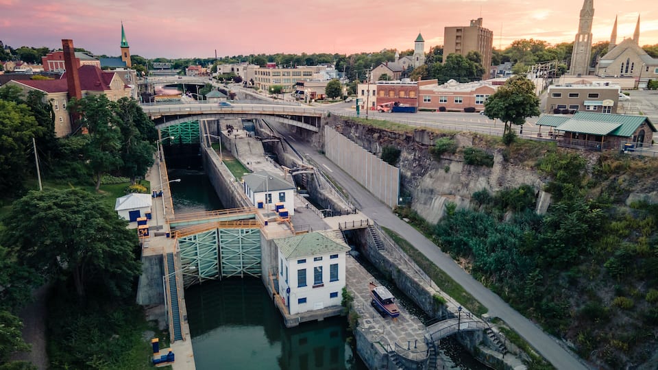 A lock system with a bridge, a church, and a river.