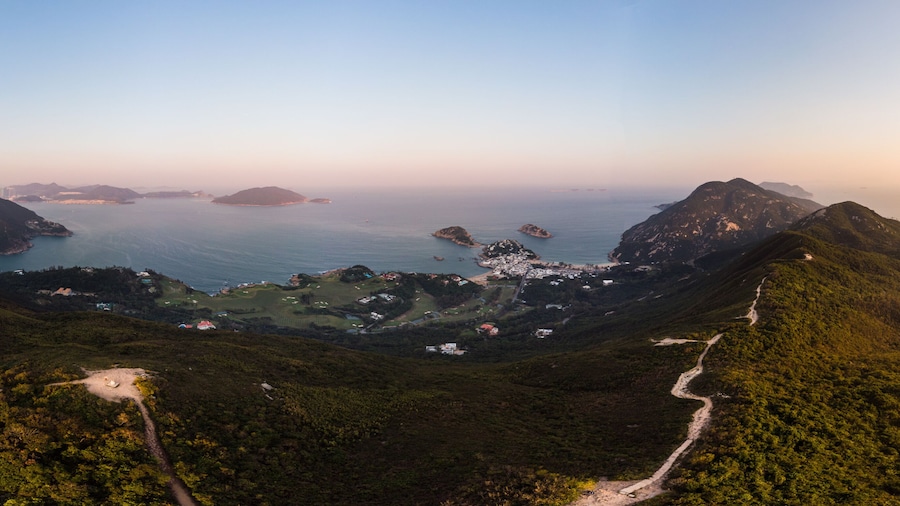 Aerial view of the sunset over the famous Dragon's back hiking trail and the Shek O village in the wild south part of Hong Kong island