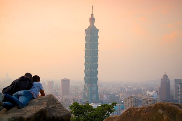 Taipei 101 showing a high-rise building, a sunset and a city