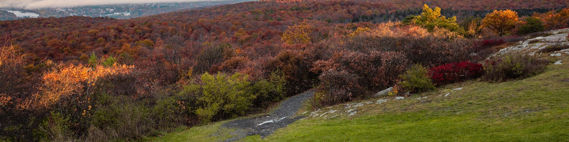 High Point State Park, NJ, overlooking tri-states with Matamoras, PA, and Port Jervis, NY, as fog rises over Delaware River on a late fall morning banner size