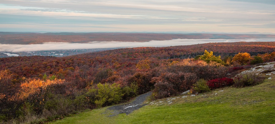 High Point State Park, NJ, overlooking tri-states with Matamoras, PA, and Port Jervis, NY, as fog rises over Delaware River on a late fall morning banner size