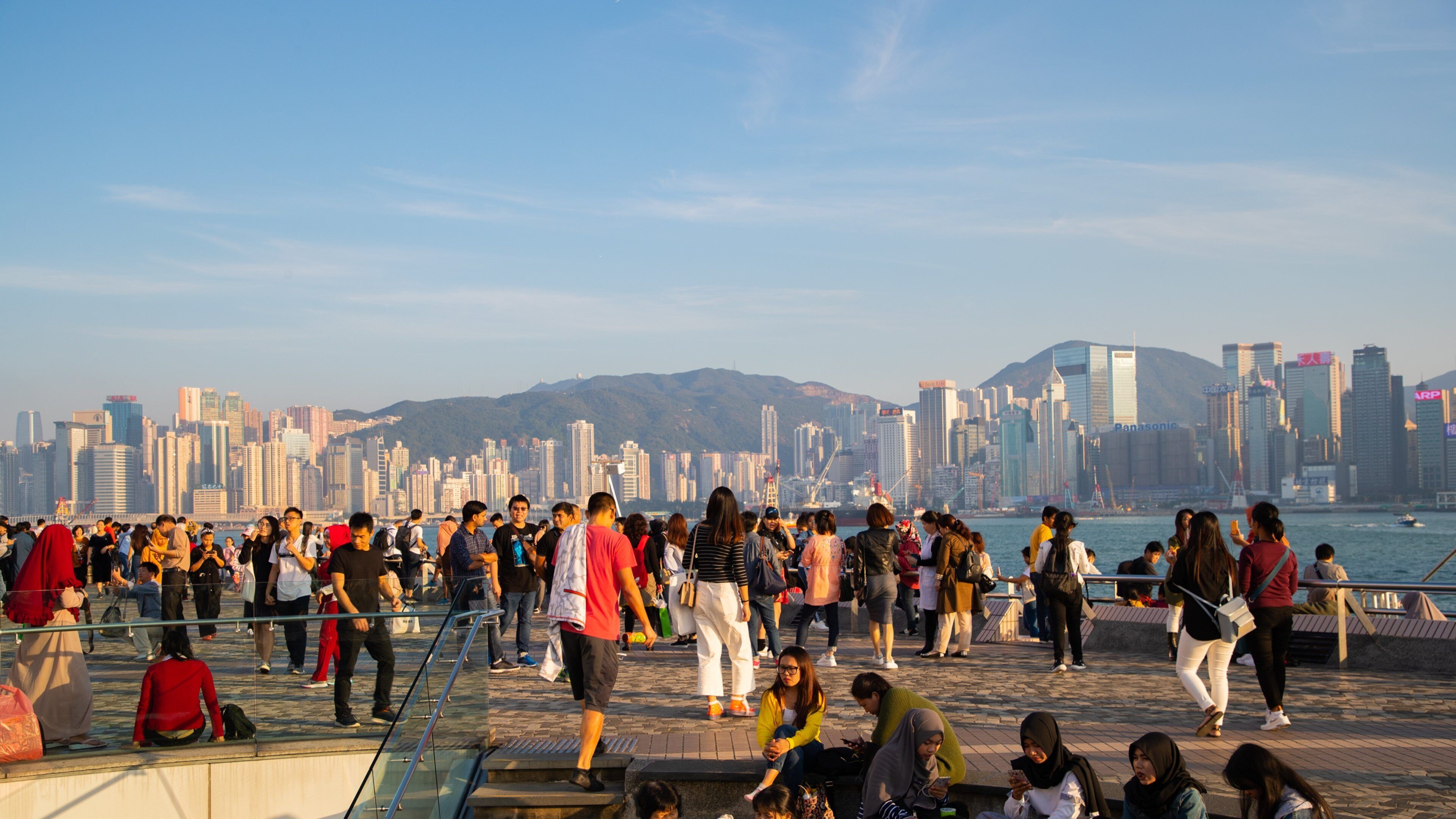 Tsim Sha Tsui Promenade featuring a city, a bay or harbor and a sunset