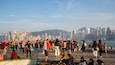 Tsim Sha Tsui Promenade featuring a city, a bay or harbor and a sunset