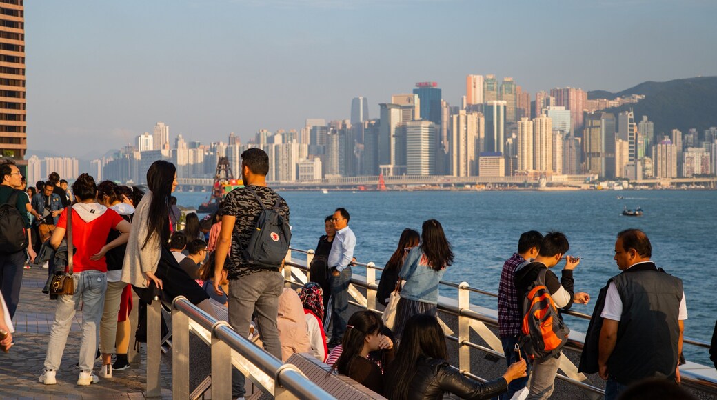 Tsim Sha Tsui Promenade which includes a city and a bay or harbor as well as a large group of people