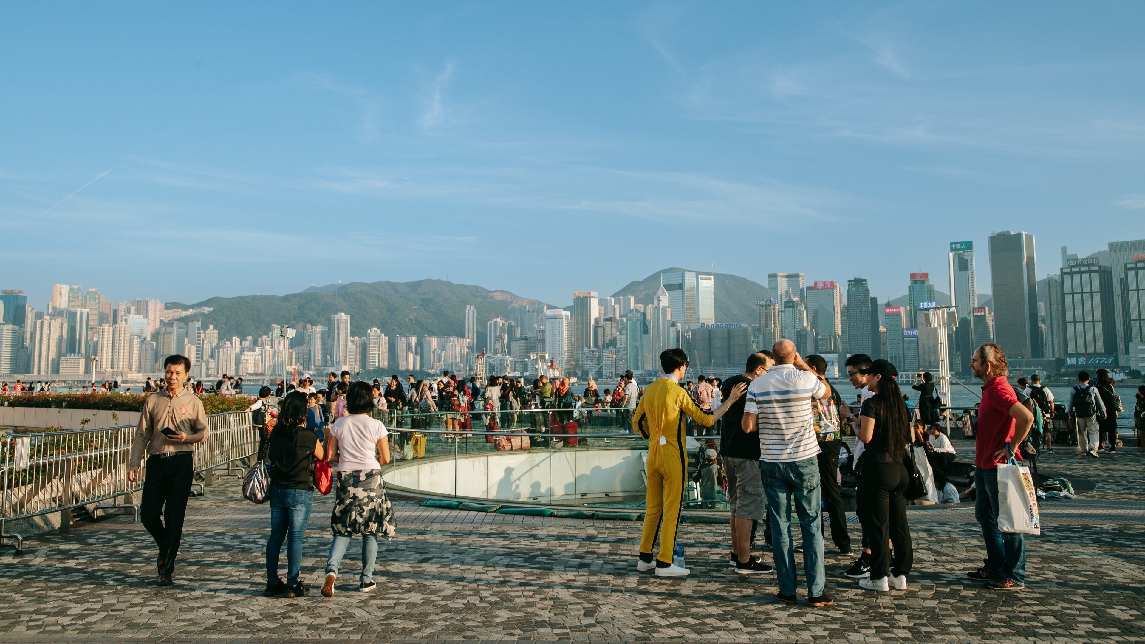 Tsim Sha Tsui Promenade which includes a city as well as a small group of people