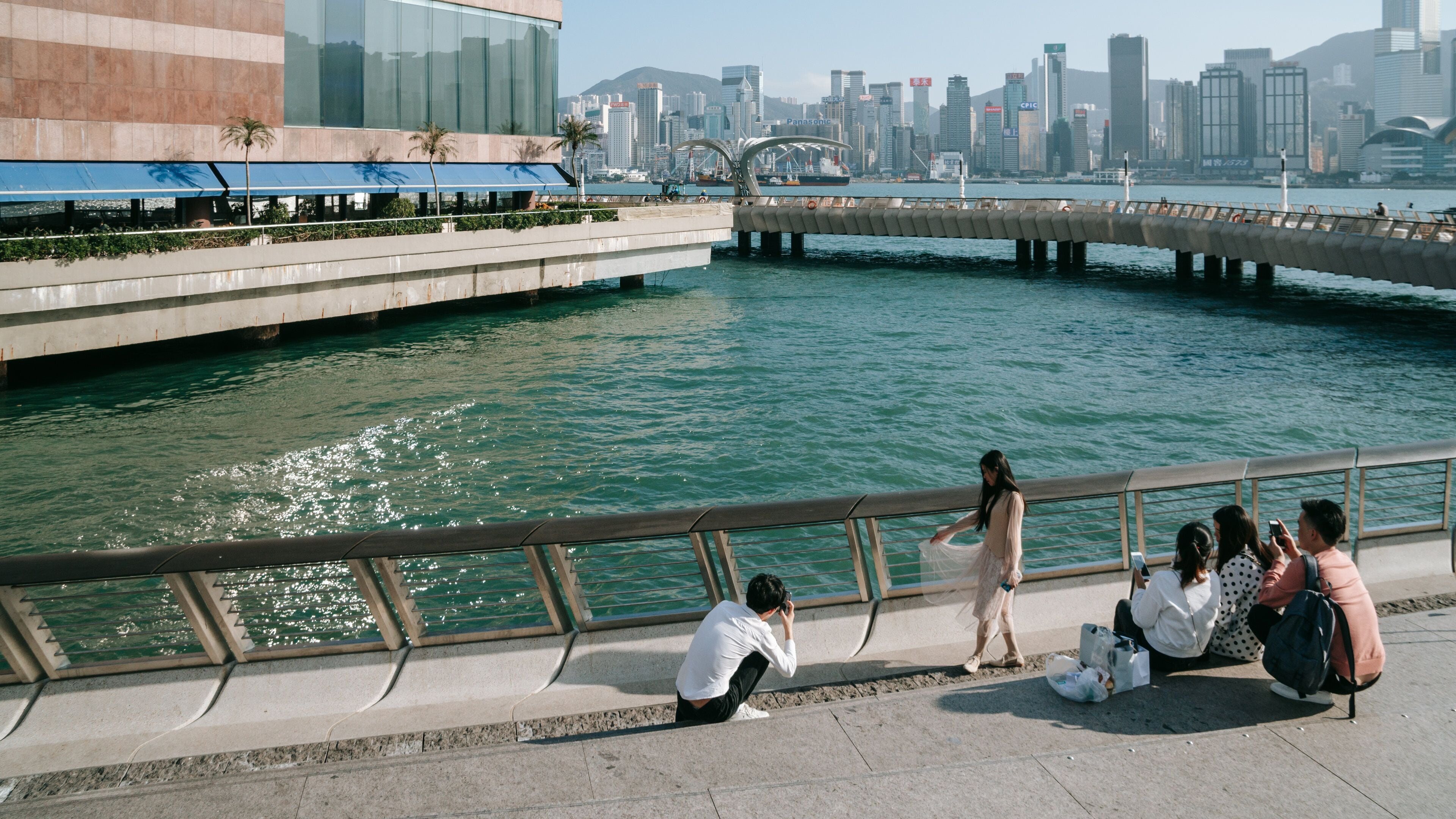 Tsim Sha Tsui Promenade featuring a bridge as well as a couple