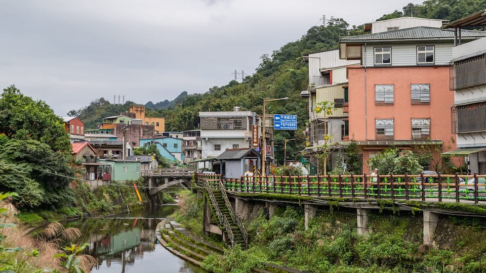 Pingxi District which includes a river or creek and a small town or village