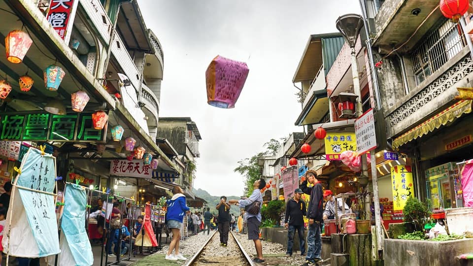 Shifen Old street is, well, technically also an active train line. Famous for being a tourist hot spot, the majority of visitors to this small town still catch the train in from Taipei. People can be found playing around in the middle of the train tracks, shopping, snacking on local delicacies and releasing sky lanterns with written wishes on them.
When a train is approaching, you will hear whistles and the guards will clear the track so that the train can pass through. Once its safe again, people return to enjoying this unique colourful experience.
#troveon #traveltherenext #shifen #taiwan @traveltherenext @qftravelinsider