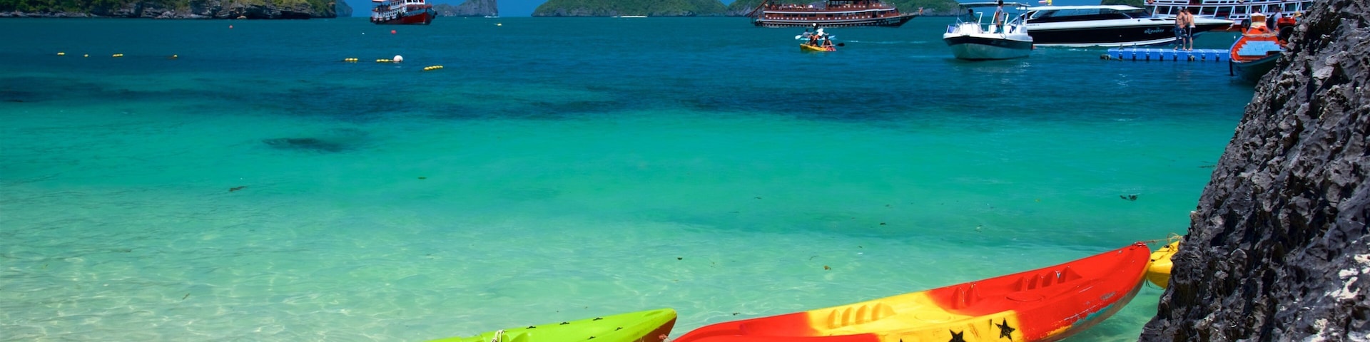 Koh Samui which includes a beach, rugged coastline and boating