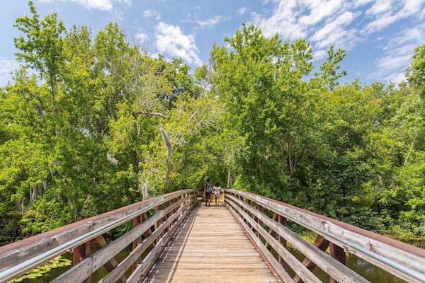 Sawgrass Lake Park featuring a bridge as well as a couple