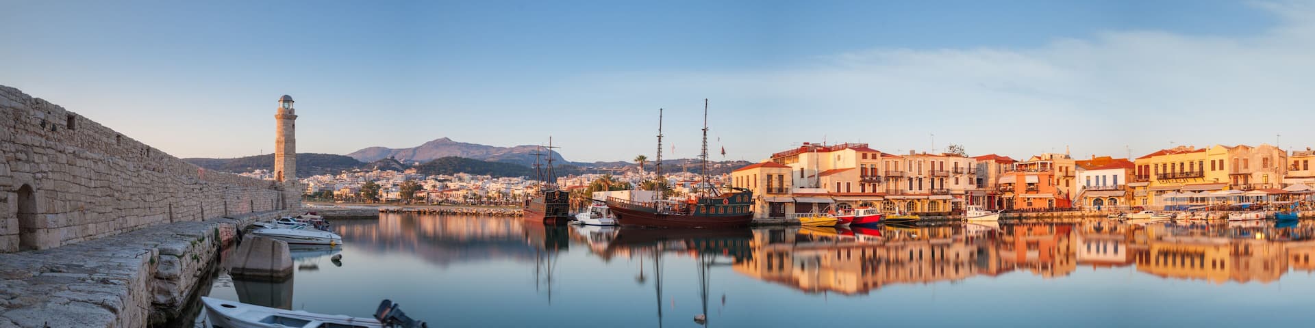 Panorama of old harbour in Rethymnon with lighthouse at sunrise Crete, Greece