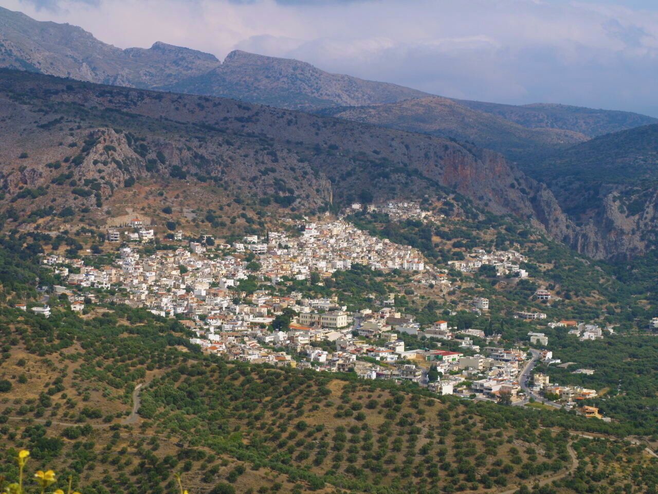 A town nestled in a valley surrounded by mountains.