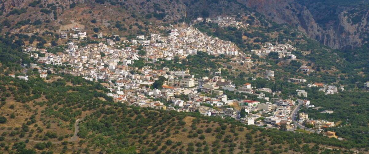 A town nestled in a valley surrounded by mountains.