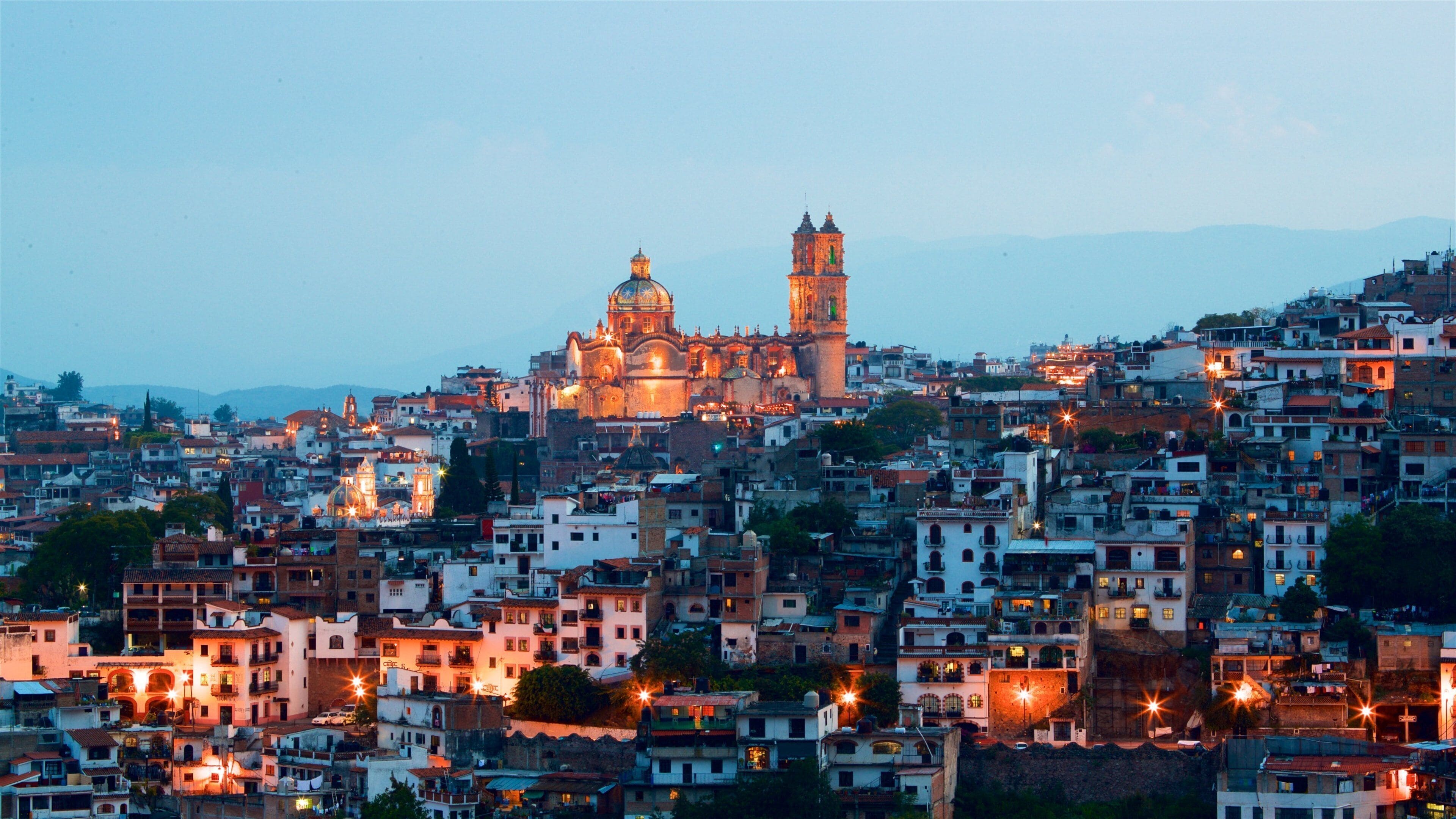 Santa Prisca Cathedral showing a city, a sunset and landscape views