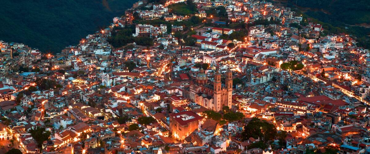 Santa Prisca Cathedral which includes a city and night scenes