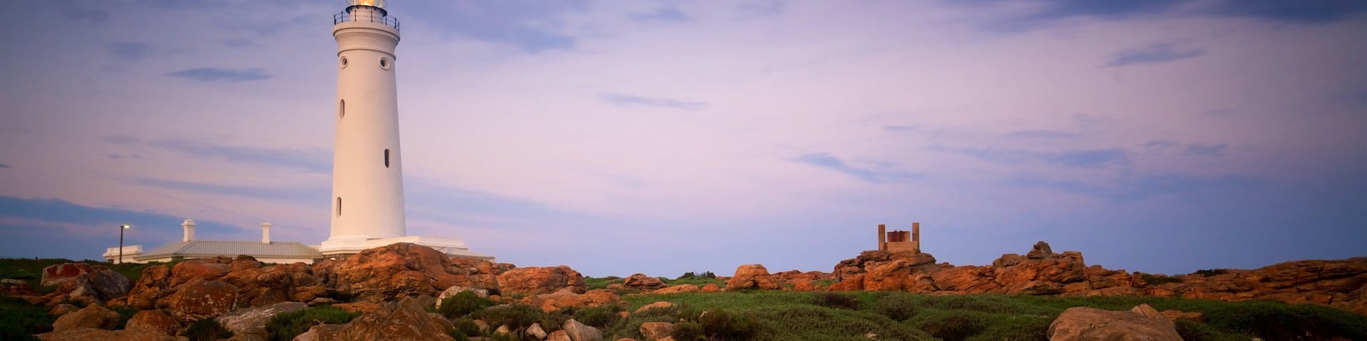 Seal Point Lighthouse featuring a sunset, general coastal views and rocky coastline