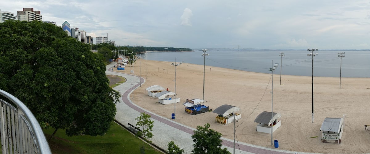 Panorama view of Ponta Negra beach in Manaus Amazon Brazil, in the afternoon with light cloudy weather, empty beach because of Corona Logdown