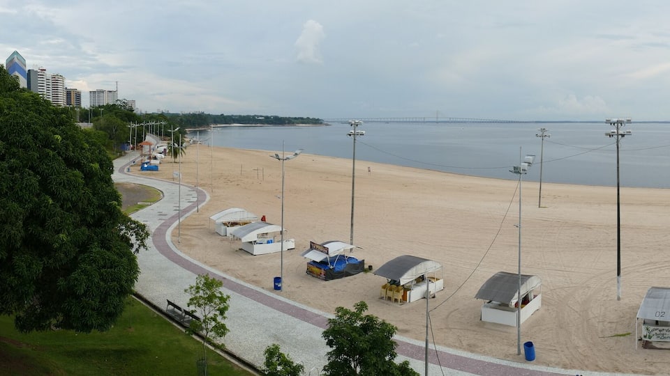 Panorama view of Ponta Negra beach in Manaus Amazon Brazil, in the afternoon with light cloudy weather, empty beach because of Corona Logdown
