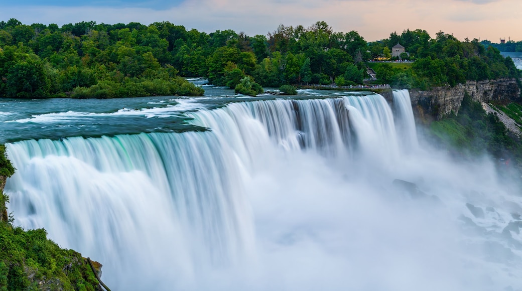 A panoramic long exposure photo of the American - Canadian waterfalls Niagara Falls in dusk.
