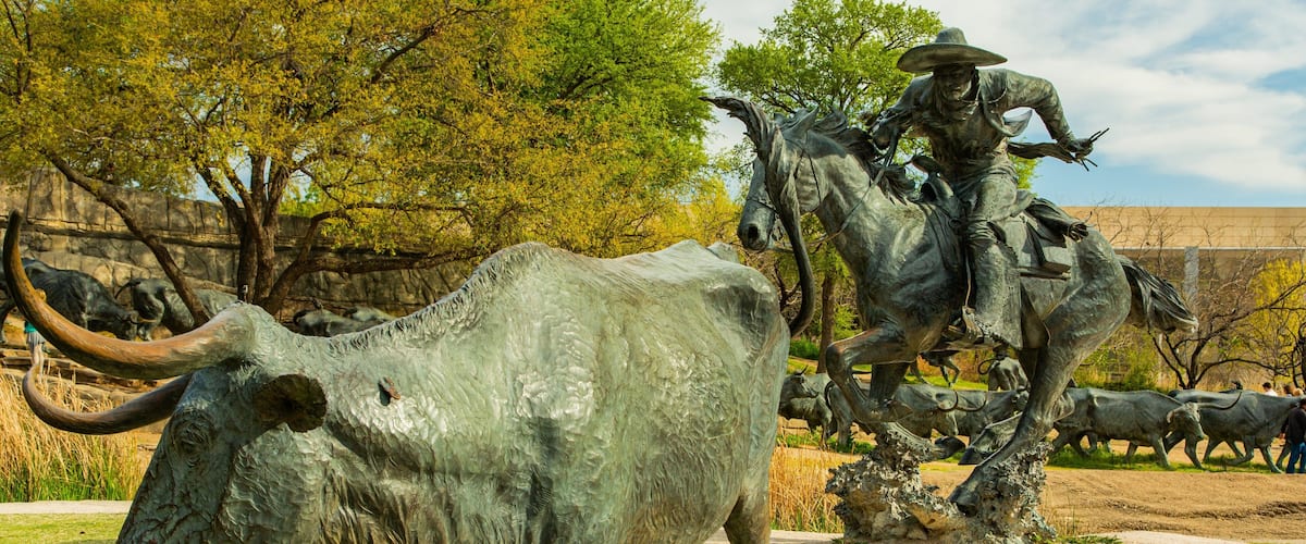 Pioneer Plaza featuring a statue or sculpture and outdoor art