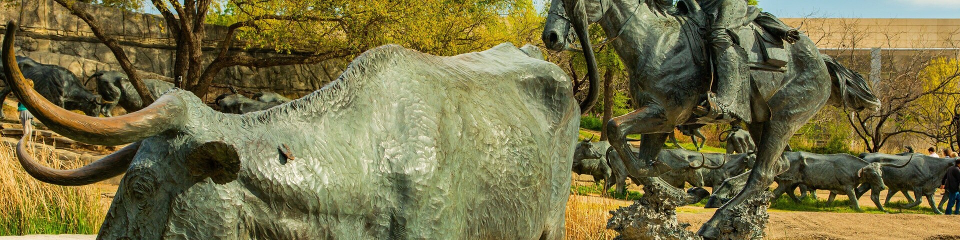 Pioneer Plaza featuring a statue or sculpture and outdoor art