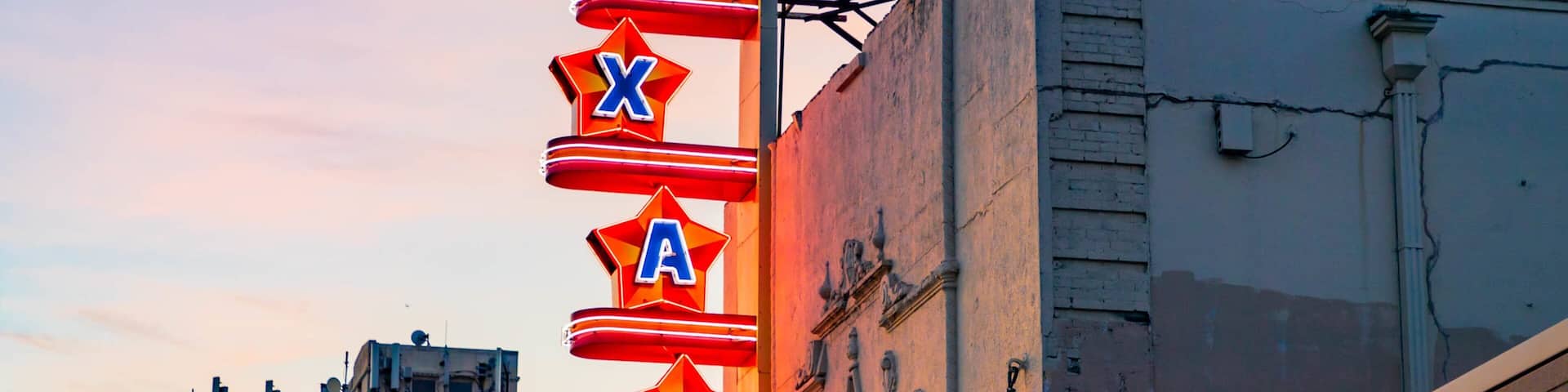 Texas Theatre which includes signage and a sunset