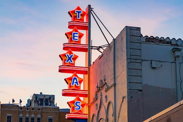 Texas Theatre which includes signage and a sunset