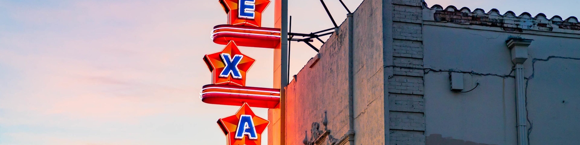 Texas Theatre which includes signage and a sunset