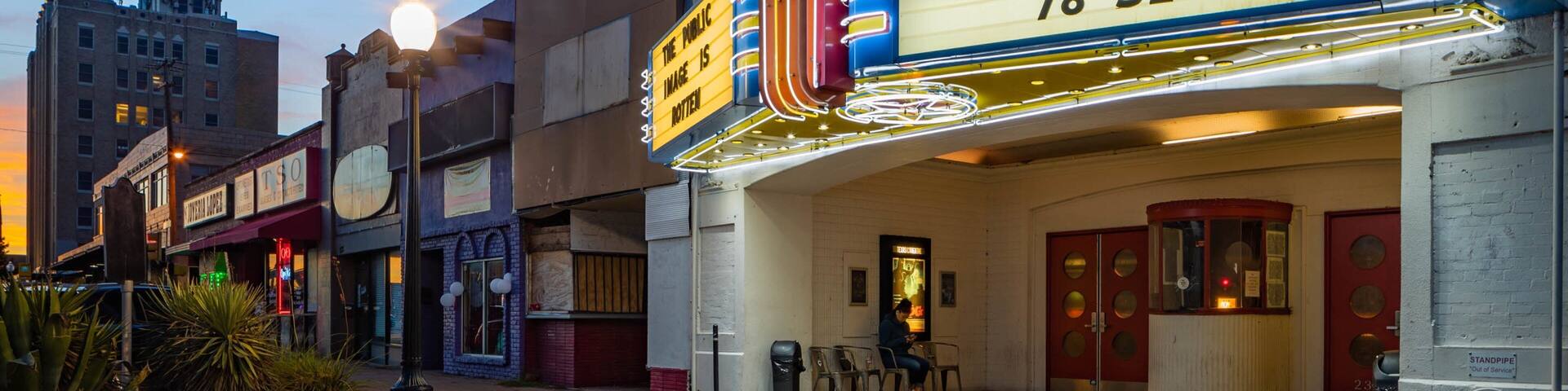 Texas Theatre showing night scenes and signage