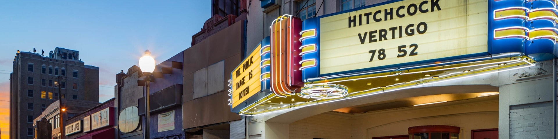 Texas Theatre showing night scenes and signage