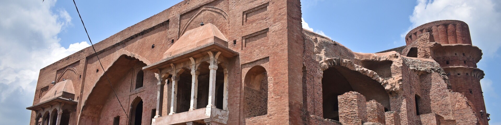 A historic building with arched windows and a large dome.