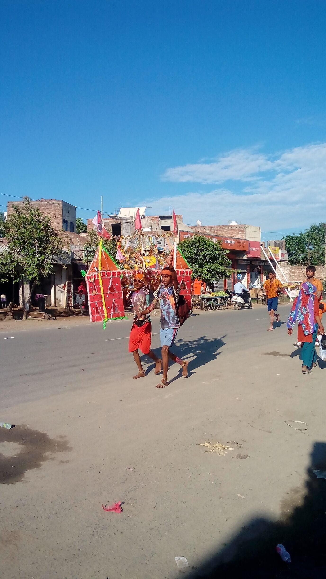 The followers of God Shiva during Kanwad Yatra ,"The Holy Travel", carrying the holy water of River Ganga for the Holy bath of the Lord Shiva at their native temple. Other followers make arrangements for their comfortable during the travel by organising road side travel camps.