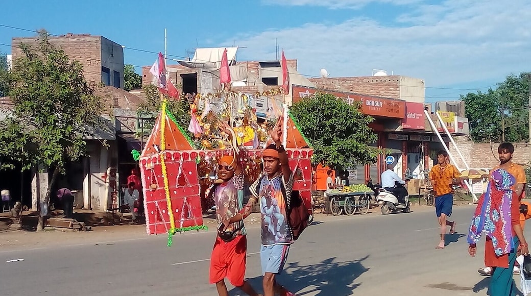 The followers of God Shiva during Kanwad Yatra ,"The Holy Travel", carrying the holy water of River Ganga for the Holy bath of the Lord Shiva at their native temple. Other followers make arrangements for their comfortable during the travel by organising road side travel camps.