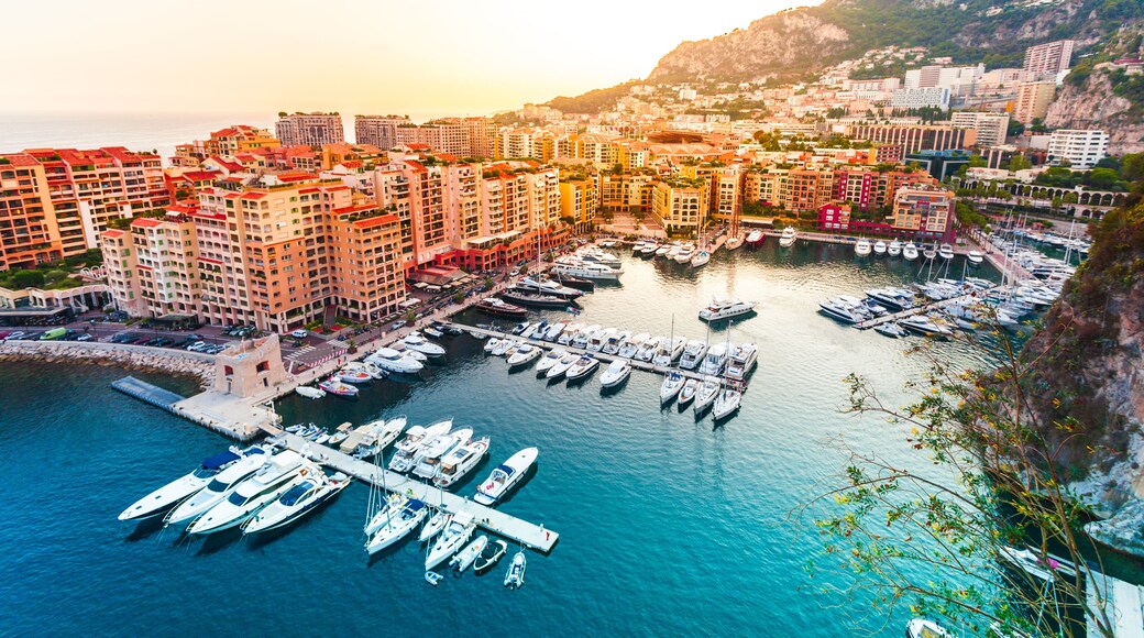 Panoramic view of Port de Fontvieille in Monaco. Azur coast. Colorful bay with a lot of luxury yachts in sunset.