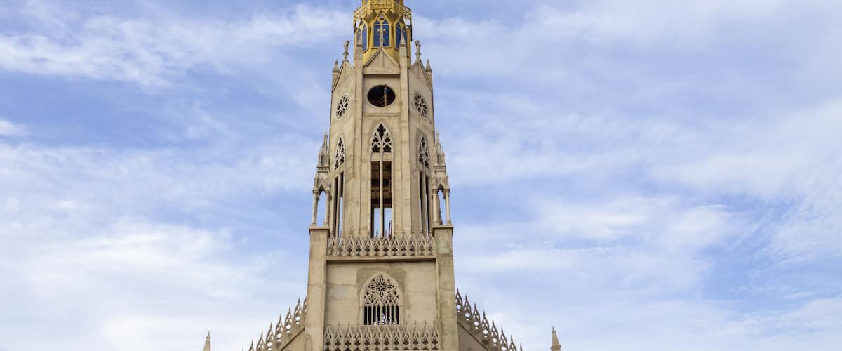 A tall, ornate church with a spire and clock tower.