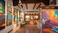 An art gallery with various paintings on display.