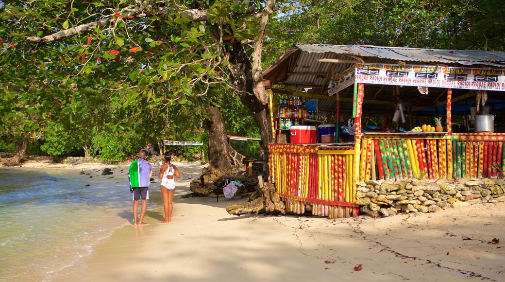 Winnifred Beach showing a beach bar and a beach as well as a small group of people