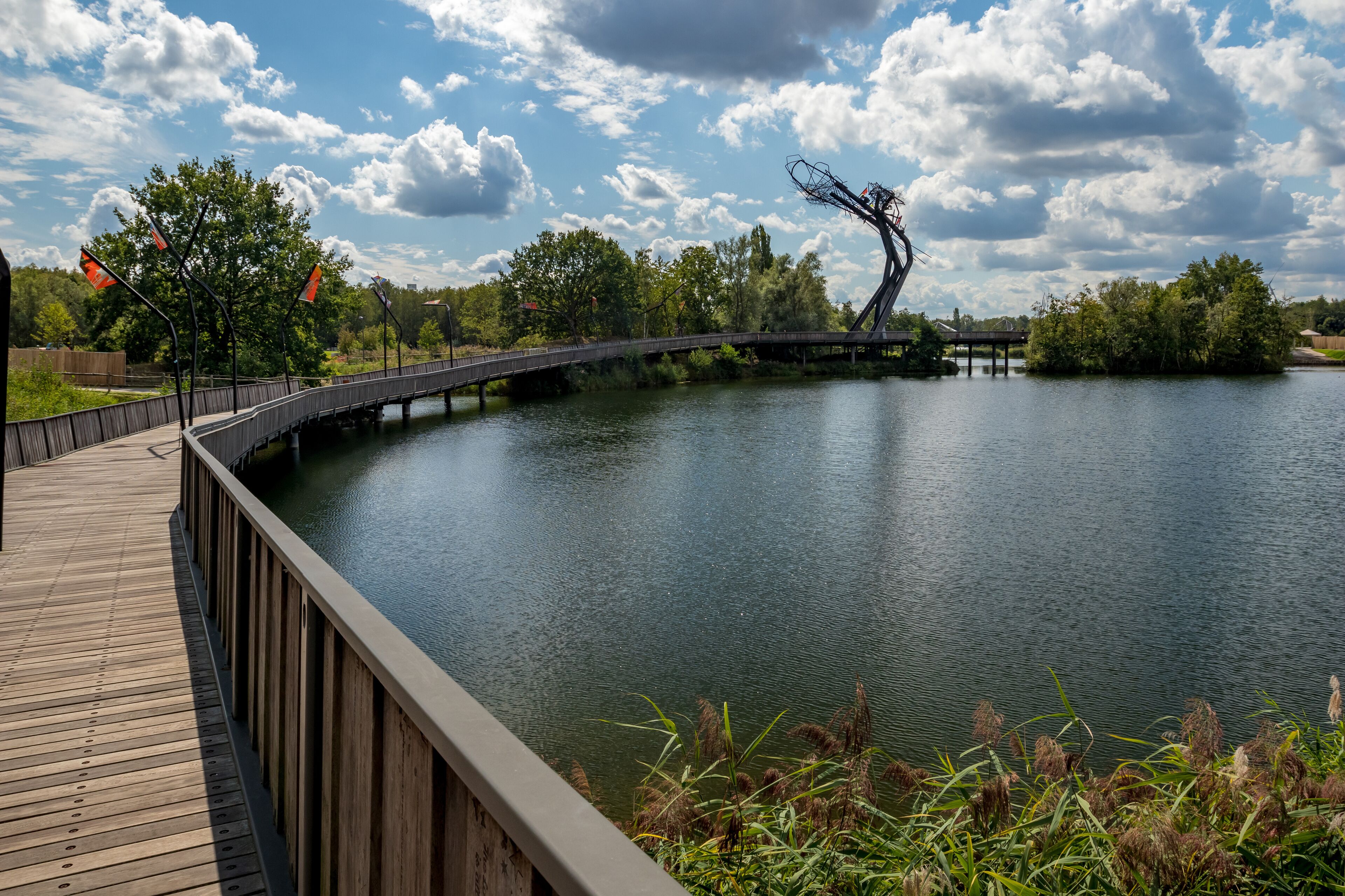 Wooden bridge with the abstract sculpture. Sunny September view from the park, Provinciaal Recreatiedomein De Schorre, Boom, Belgium