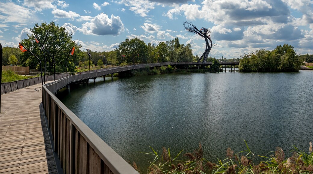 Wooden bridge with the abstract sculpture. Sunny September view from the park, Provinciaal Recreatiedomein De Schorre, Boom, Belgium
