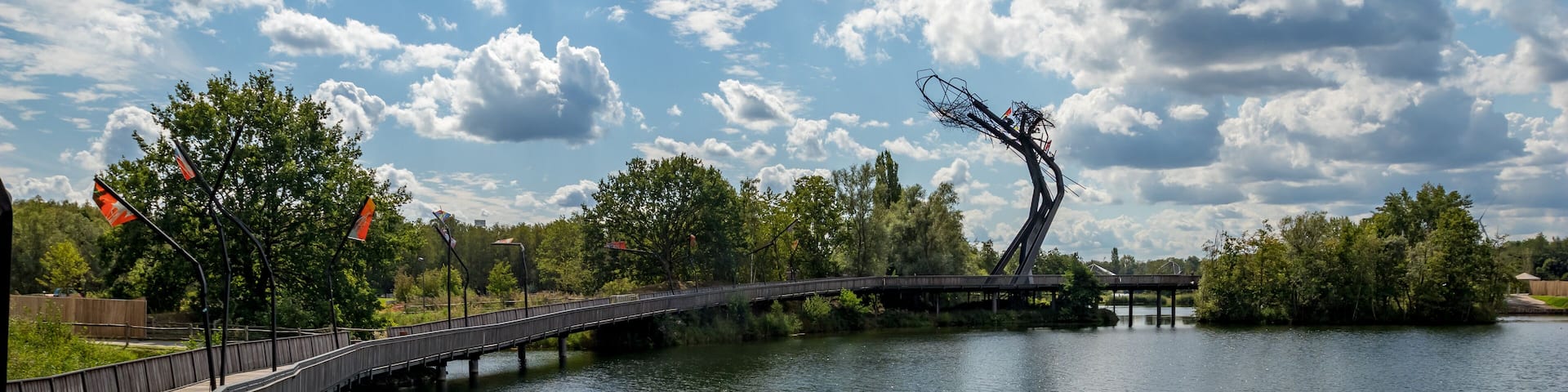 Wooden bridge with the abstract sculpture. Sunny September view from the park, Provinciaal Recreatiedomein De Schorre, Boom, Belgium