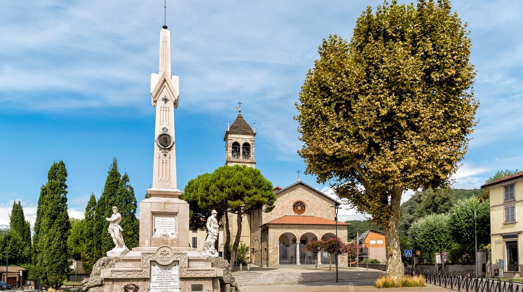 Central square with Memorial monument to the fallen and Church in the City of San Fermo della Battaglia, province of Como, Italy