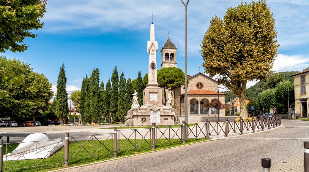 Central square with Memorial monument to the fallen and Church in the City of San Fermo della Battaglia, province of Como, Italy