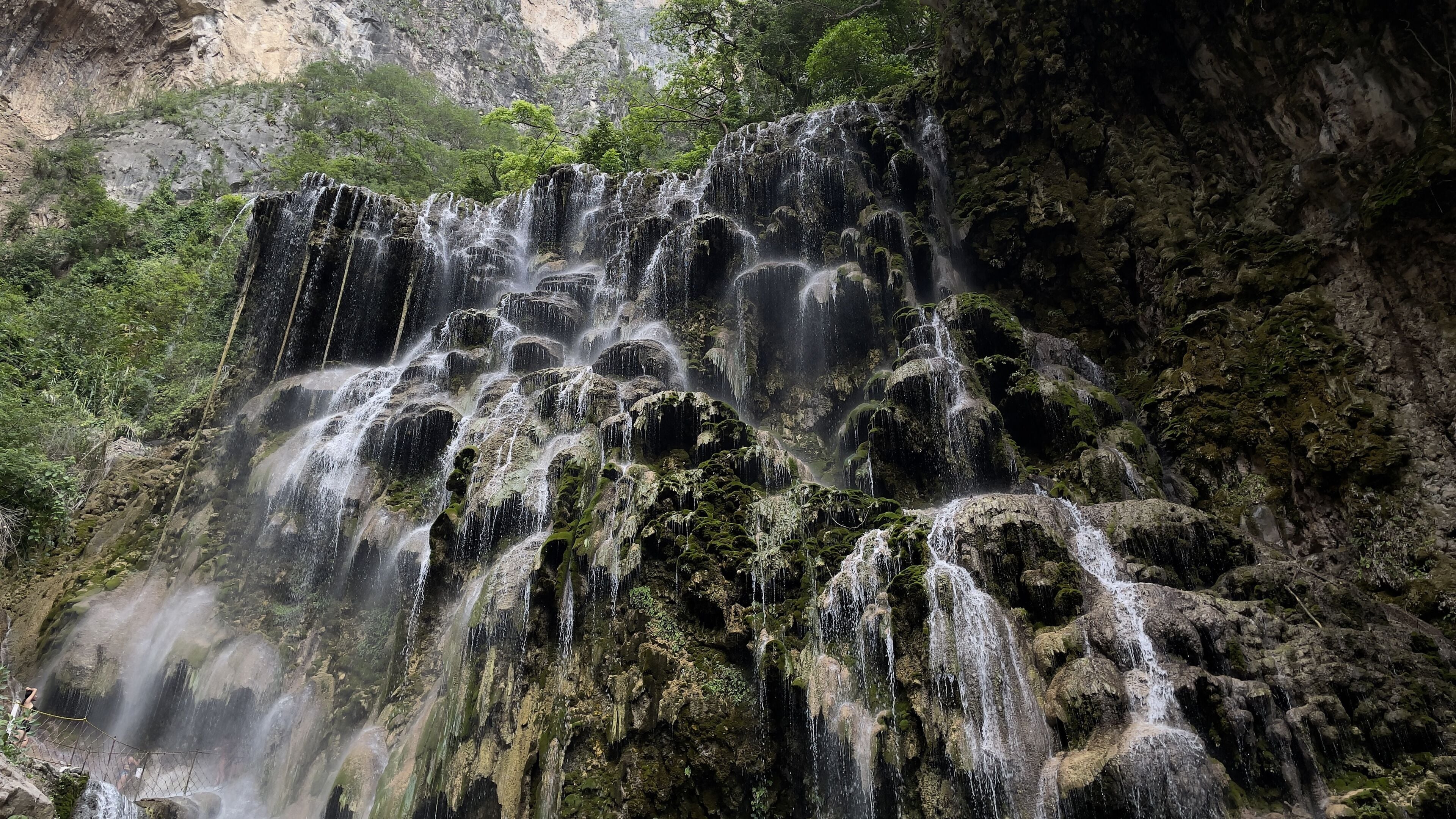 Grutas Tolantongo waterfall in a forest in the daylight in Mexico