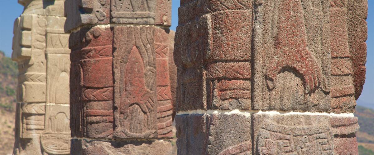 Ancient stone carvings on a column with intricate designs and patterns.