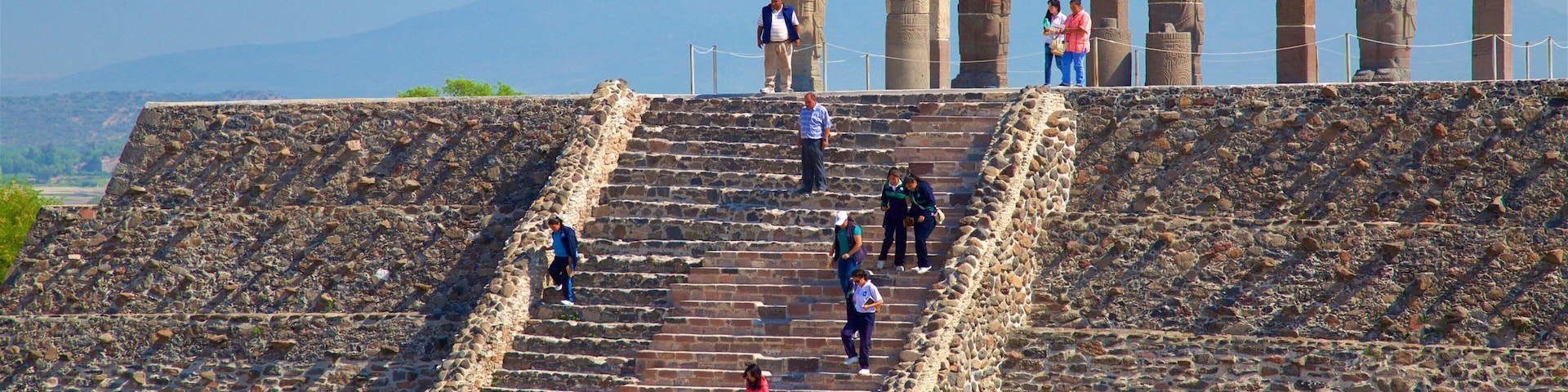 Tula Archaeological Site featuring heritage architecture as well as a small group of people